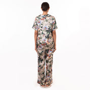 Woman standing with her back to the camera wearing a floral print Anuschka pajama set - 3344.