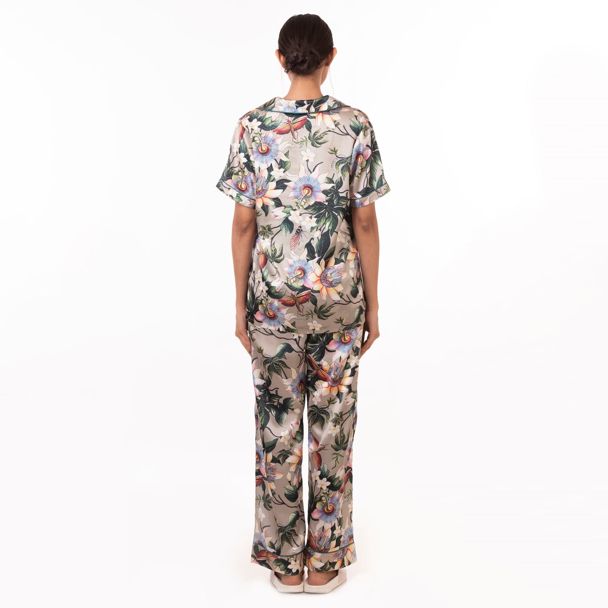 Woman standing with her back to the camera wearing a floral print Anuschka pajama set - 3344.