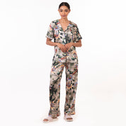 A woman stands posing in Anuschka's Pajama Set - 3344 made of recycled fabric against a white background.