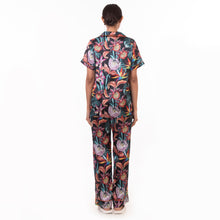 Load image into Gallery viewer, A woman facing away from the camera, dressed in an Anuschka floral patterned Pajama Set - 3344.
