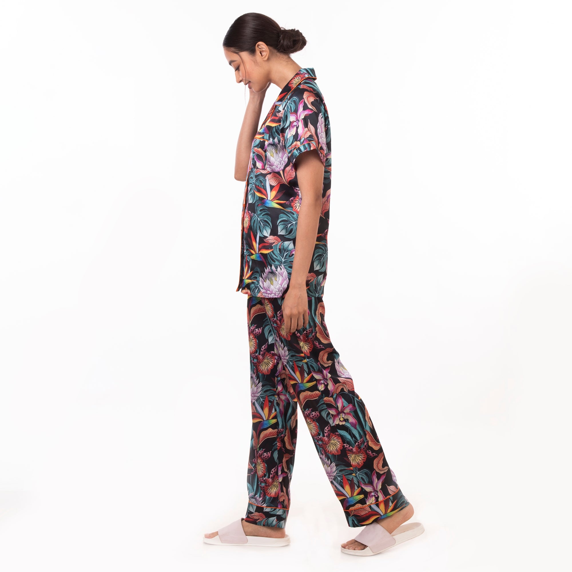 Woman in Anuschka tropical print pajama set - 3344 walking against a white background.