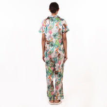 Load image into Gallery viewer, Woman wearing a tropical print Anuschka pajama set - 3344, seen from behind, crafted from recycled fabric.
