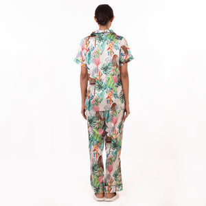 Woman wearing a tropical print Anuschka pajama set - 3344, seen from behind, crafted from recycled fabric.
