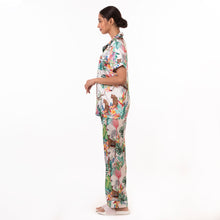 Load image into Gallery viewer, A woman in an Anuschka floral Pajama Set - 3344 standing in profile against a white background.
