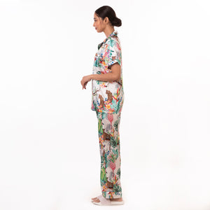 A woman in an Anuschka floral Pajama Set - 3344 standing in profile against a white background.