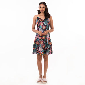 A woman poses in a delicate floral Anuschka slip dress - 3346 against a white background.