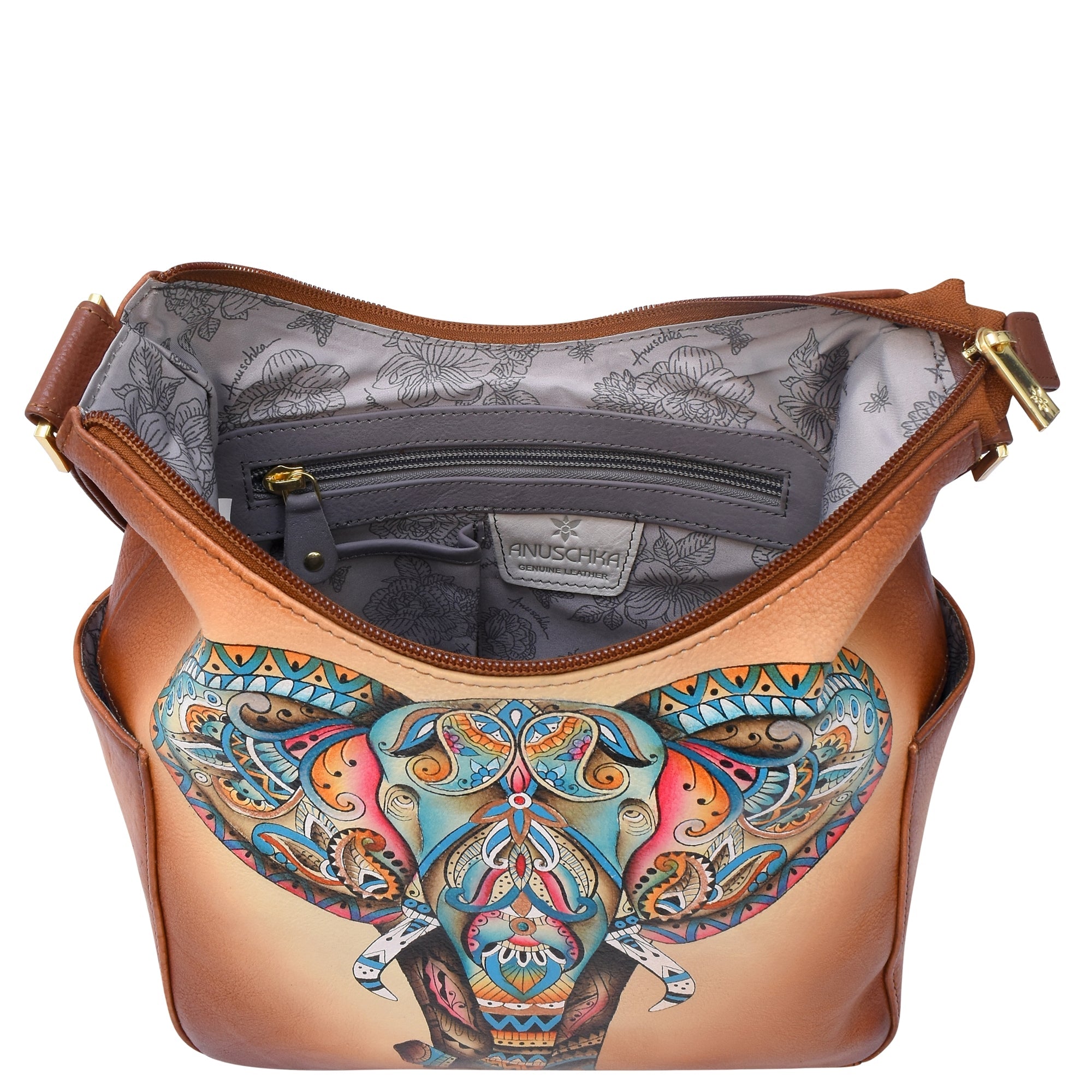 The Anuschka Classic Hobo With Side Pockets - 382 is a genuine leather handbag featuring vibrant, hand-painted elephant artwork on the front. When unzipped, it reveals a floral-patterned interior along with an inner zip pocket for added convenience.