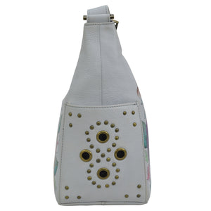 White Anuschka Classic Hobo With Studded Side Pockets - 433 backpack with metal grommet embellishments on a plain background.