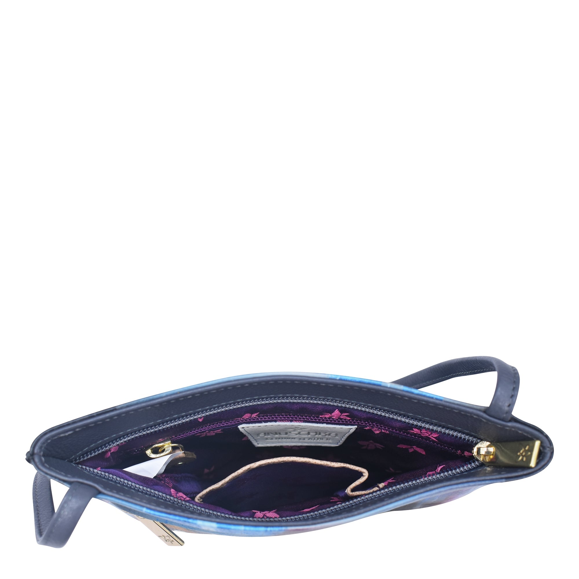 Open Anuschka Slim Crossbody With Front Zip - 452 in dark forest green leather with a wrist strap, showing the interior with purple fabric lining, pink butterfly pattern, and compartments including a zipper pocket.