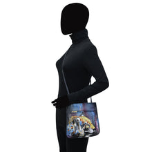 Load image into Gallery viewer, A silhouette of a person with a blacked-out face wearing a black turtleneck and an Anuschka Slim Crossbody With Front Zip - 452 in dark forest green with a lion design crafted from genuine leather.
