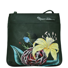 Load image into Gallery viewer, Black leather backpack featuring a floral design with a prominent yellow lily and dark red rose, signed by Anuschka, now upgraded with a Slim Crossbody With Front Zip - 452 sling strap.
