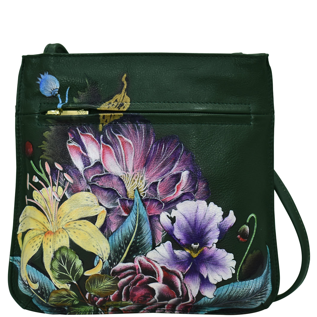 A green Anuschka genuine leather crossbody bag featuring a vibrant floral and butterfly print.