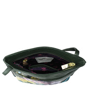 Open black Anuschka Slim Crossbody With Front Zip - 452 purse displaying contents and a floral interior, isolated on a white background with a sling crossbody strap.