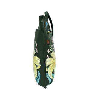 Black umbrella with a floral print featuring yellow and blue flowers, adorned with a Anuschka Slim Crossbody With Front Zip - 452, viewed from the side against a white background.