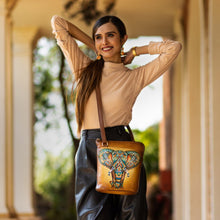 Load image into Gallery viewer, Woman posing with an Anuschka Organizer Crossbody With Extended Side Zipper - 493 outdoors.
