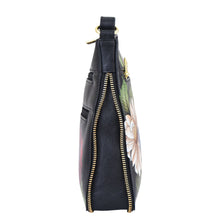 Load image into Gallery viewer, Side view of a floral-print Anuschka Expandable Travel Crossbody - 550 with a zipper closure.
