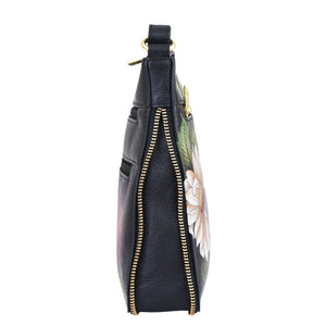 Side view of a floral-print Anuschka Expandable Travel Crossbody - 550 with a zipper closure.