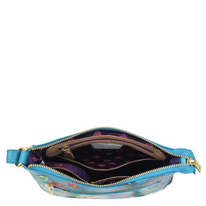 Anuschka Expandable Travel Crossbody - 550 with floral interior design and open zipper, isolated on white background.