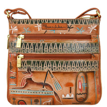 Load image into Gallery viewer, The Expandable Travel Crossbody - 550 by Anuschka is a genuine leather bag boasting intricate, colorful Egyptian-inspired hand-painted artwork with hieroglyphics and figures. It features two zippered compartments and an adjustable strap.
