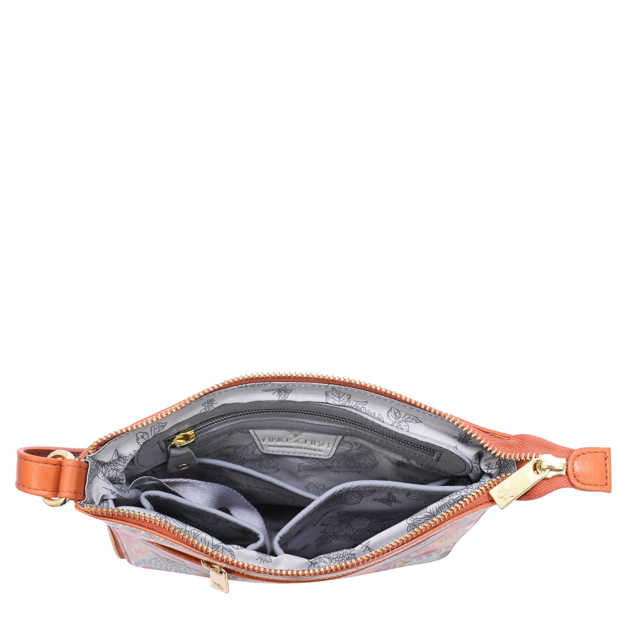 The Anuschka Expandable Travel Crossbody - 550 is a small, opened brown handbag made of genuine leather with a gold zipper, featuring multiple inner compartments and pockets lined with grey patterned fabric.