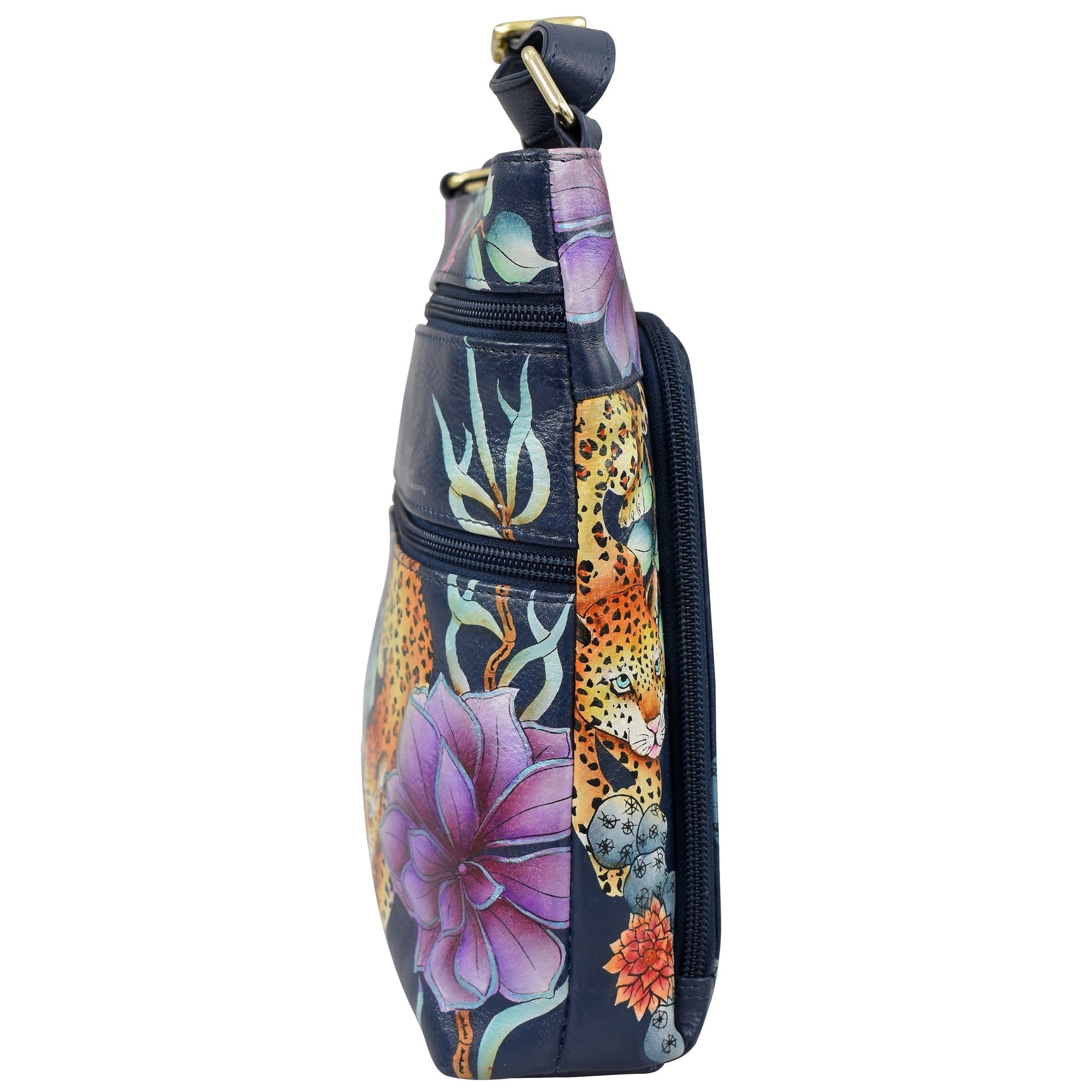 Side view of an Anuschka Crossbody With Front Zip Organizer - 651, a dark, hand-painted leather bag adorned with leopards, purple flowers, and green foliage. This stylish accessory includes an RFID protected organizer and a zipper pocket.