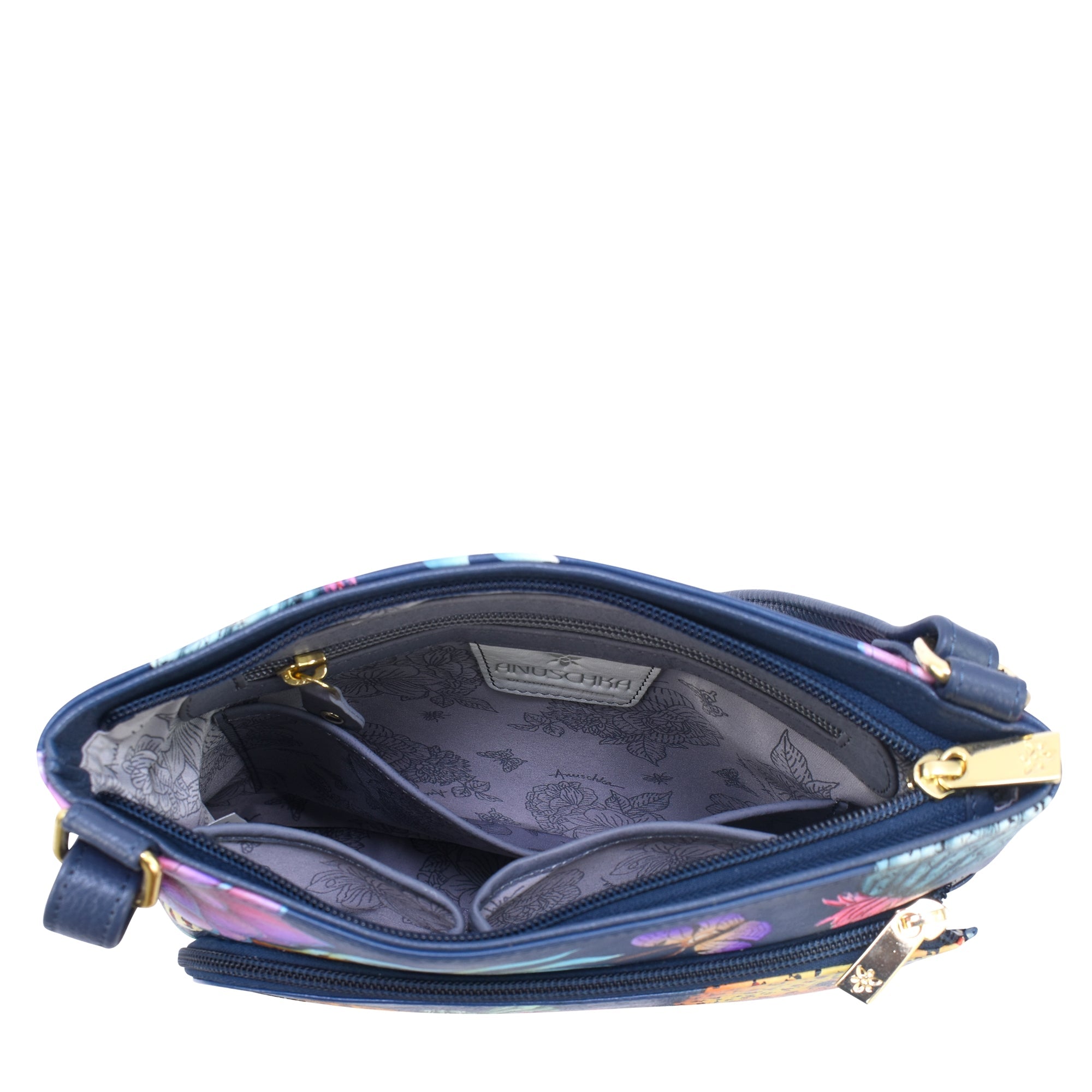 Top view of an open blue floral-patterned handbag with two main compartments, a gold zipper, and an interior pocket lined with light gray floral fabric. This hand-painted leather crossbody from Anuschka, named the Crossbody With Front Zip Organizer - 651, features an adjustable crossbody strap and includes an RFID-protected organizer for added security.