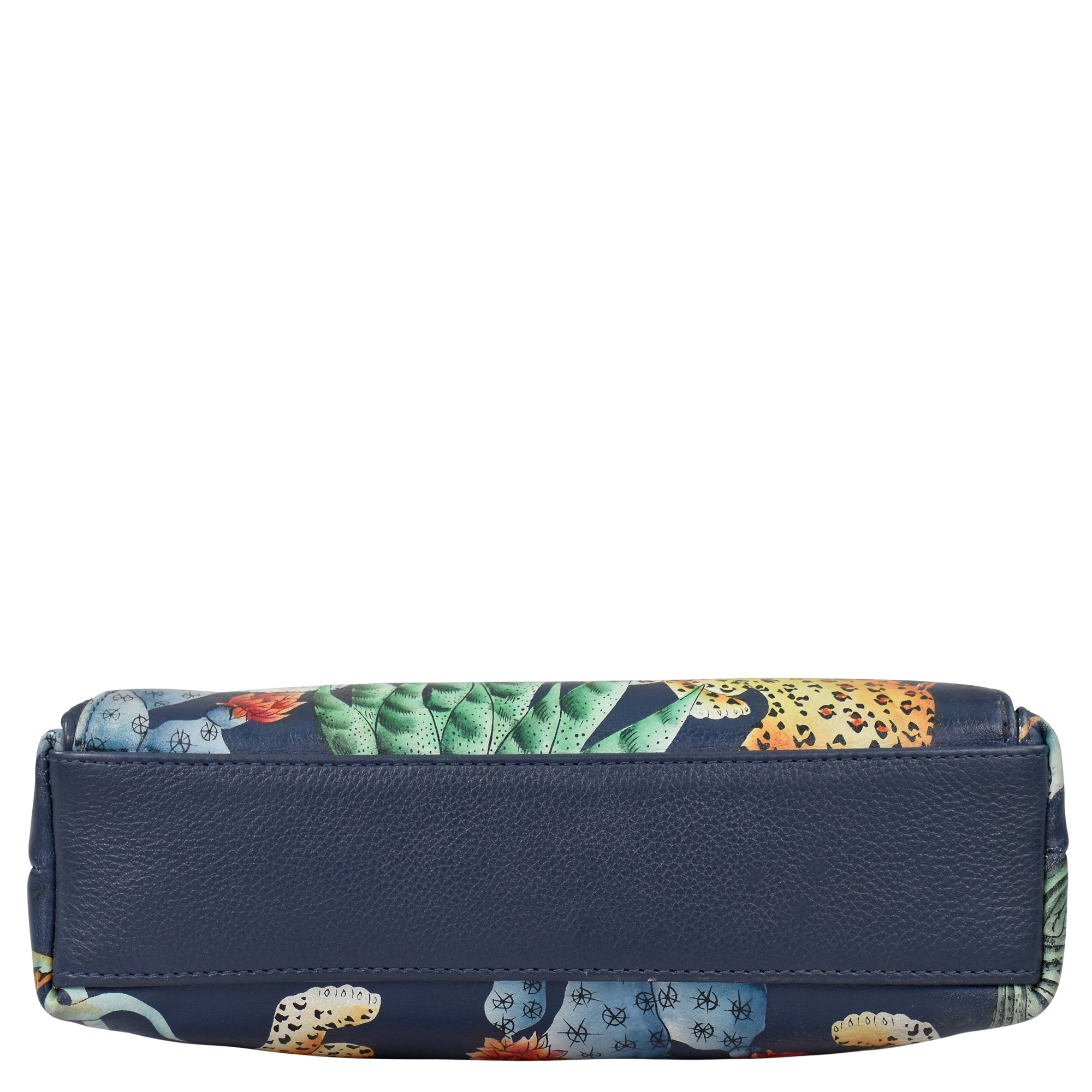 The Anuschka Crossbody With Front Zip Organizer - 651 is a rectangular handbag featuring a blue leather bottom and adorned with a tropical print of leaves and leopards, complete with an adjustable crossbody strap.