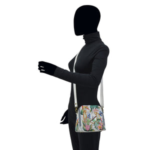 Mannequin wearing a chic black turtleneck, blazer, and an Anuschka Zip Around Travel Organizer - 668 that's RFID protected, isolated on a white background.