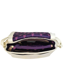Load image into Gallery viewer, Open Anuschka Flap Crossbody - 683 revealing a purple floral interior with compartments and a crossbody strap.
