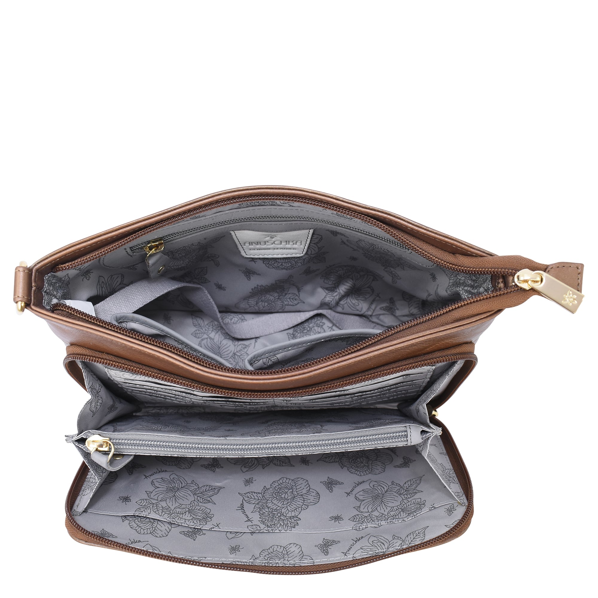 An Anuschka Shoulder Organizer - 684, crafted from brown genuine leather and adorned with gold zippers, opens to showcase a floral-patterned gray interior complete with multiple compartments and a removable crossbody strap for added versatility.