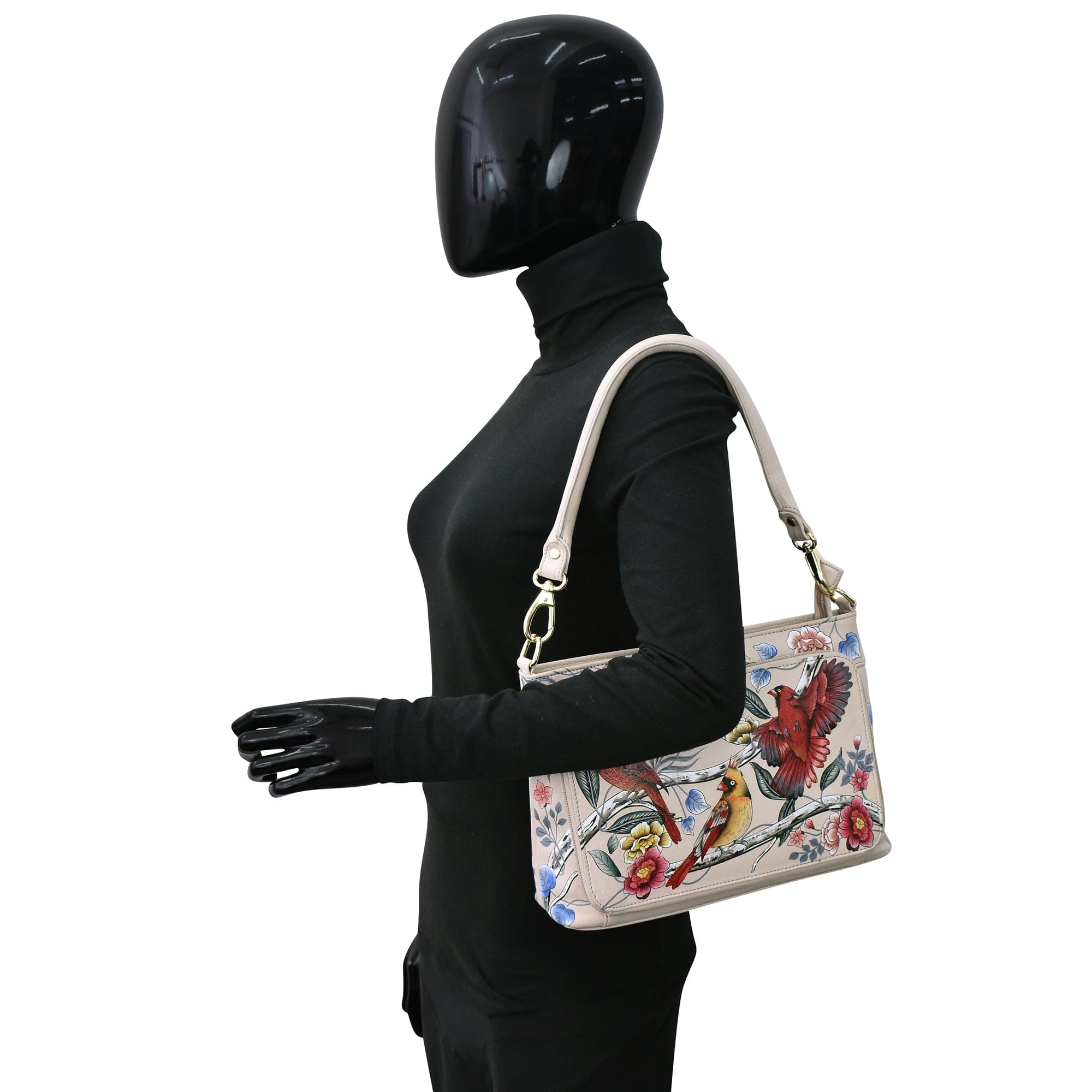 Mannequin with black attire and gloves showcasing an Anuschka Large RFID Organizer - 684 with bird designs.