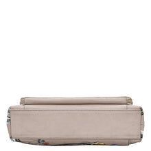 Load image into Gallery viewer, Beige leather clutch purse with floral pattern accents on a white background.
