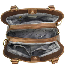 Load image into Gallery viewer, The Anuschka Multi Compartment Satchel - 690 is an open brown genuine leather handbag with a patterned fabric interior, featuring two main compartments, a middle zippered pocket, and several smaller sections for organization. It showcases gold-tone hardware and includes an adjustable shoulder strap.
