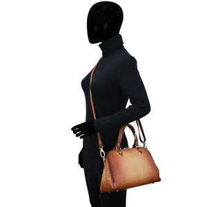 Mannequin with a black bodysuit and gloves holding a Anuschka Wide Organizer Satchel - 695.