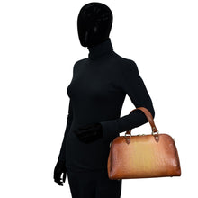 Load image into Gallery viewer, Mannequin dressed in black clothing holding a Anuschka Wide Organizer Satchel - 695.
