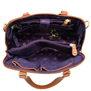 Open Anuschka Wide Organizer Satchel - 695 with a purple star-patterned interior and gold-tone hardware.