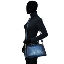 Load image into Gallery viewer, Mannequin in a black outfit carrying a blue Anuschka Wide Organizer Satchel - 695.
