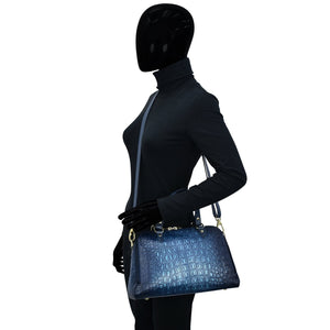 Mannequin in a black outfit carrying a blue Anuschka Wide Organizer Satchel - 695.