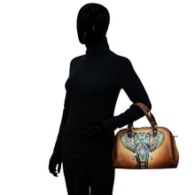Load image into Gallery viewer, A mannequin dressed in a black turtleneck and gloves holding an Anuschka Wide Organizer Satchel - 695 decorated with hand-painted artwork.
