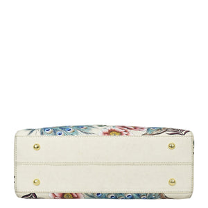 White floral and peacock feather print Anuschka genuine leather wide organizer satchel with gold-tone stud accents.