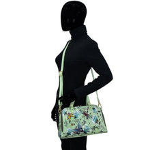 Load image into Gallery viewer, Mannequin displaying a Wide Organizer Satchel - 695 by Anuschka in a zip-around style with floral print.
