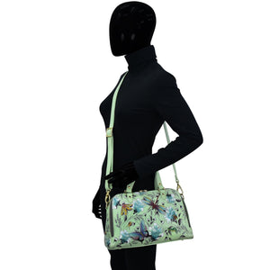 Mannequin displaying a Wide Organizer Satchel - 695 by Anuschka in a zip-around style with floral print.