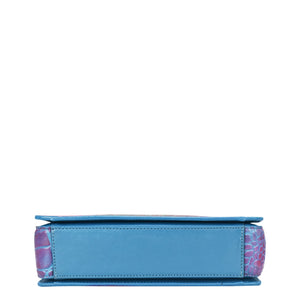 A side view of a blue and pink Anuschka Triple Compartment Crossbody - 696 wallet, organized against a white background.