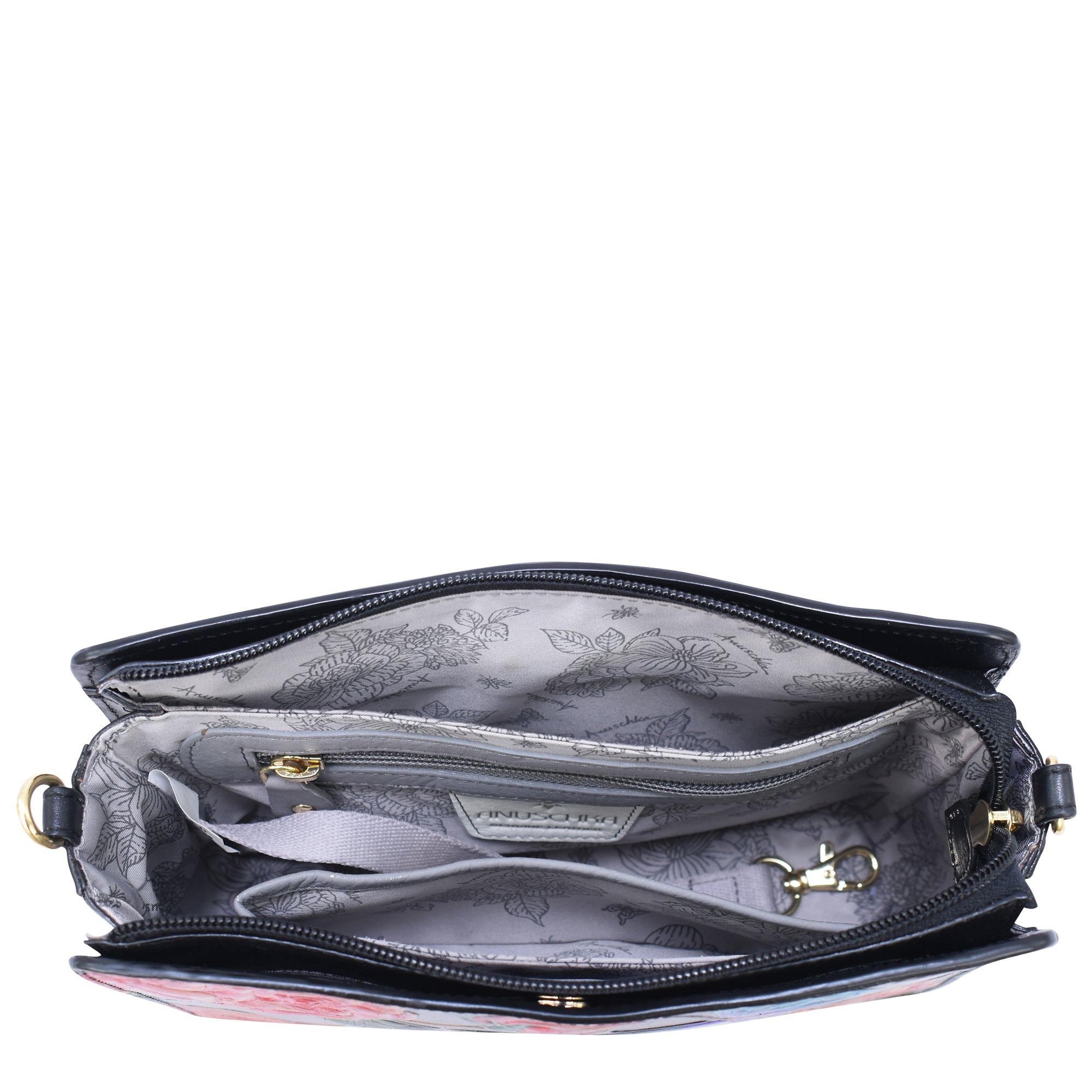 Top view of the Anuschka Triple Compartment Crossbody - 696 in genuine leather, showcasing its triple compartments lined with a floral pattern, a zipper pocket, and an adjustable detachable strap inside.