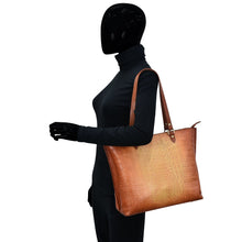 Load image into Gallery viewer, Mannequin dressed in black attire holding an Anuschka Large Zip Top Tote - 698 over its shoulder.
