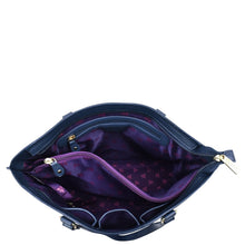 Load image into Gallery viewer, Open empty Anuschka Large Zip Top Tote - 698 with a purple star-patterned interior and gold-tone zippers, isolated on a white background. This genuine leather tote features hand-painted details that enhance its unique appeal.
