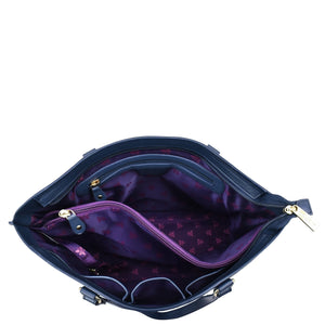Open empty Anuschka Large Zip Top Tote - 698 with a purple star-patterned interior and gold-tone zippers, isolated on a white background. This genuine leather tote features hand-painted details that enhance its unique appeal.