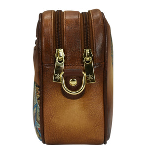 Anuschka Twin Top Messenger - 704, with dual zippers, a decorative metal ring on the front, and an adjustable strap.