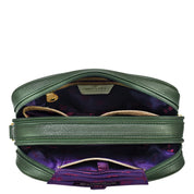 An open green leather Twin Top Messenger - 704 with a purple interior lining, by Anuschka, featuring multiple compartments, zippers, and a snap closure on one of the inside pockets. This structured purse includes a removable adjustable strap for versatile carrying options.