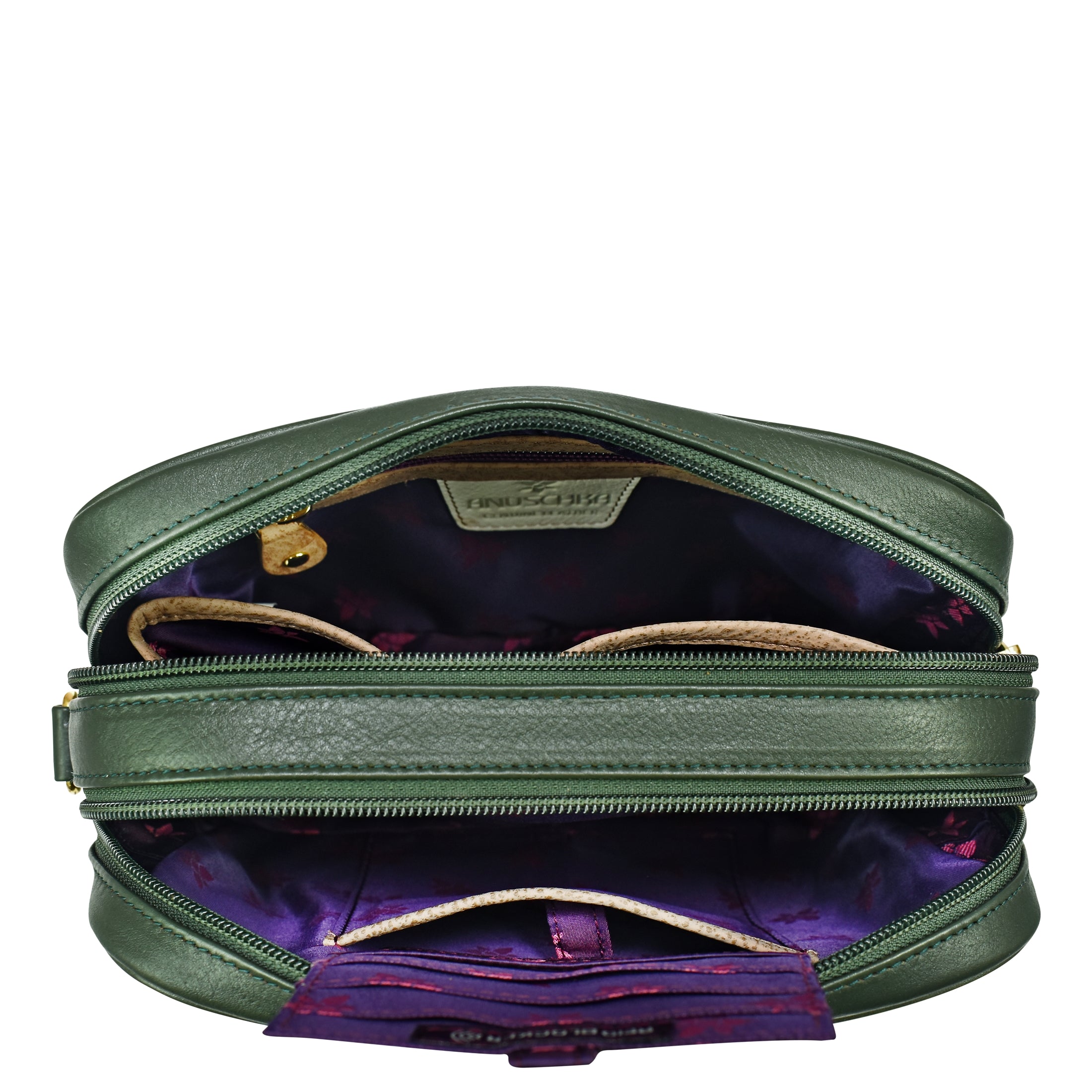 An open green leather Twin Top Messenger - 704 with a purple interior lining, by Anuschka, featuring multiple compartments, zippers, and a snap closure on one of the inside pockets. This structured purse includes a removable adjustable strap for versatile carrying options.